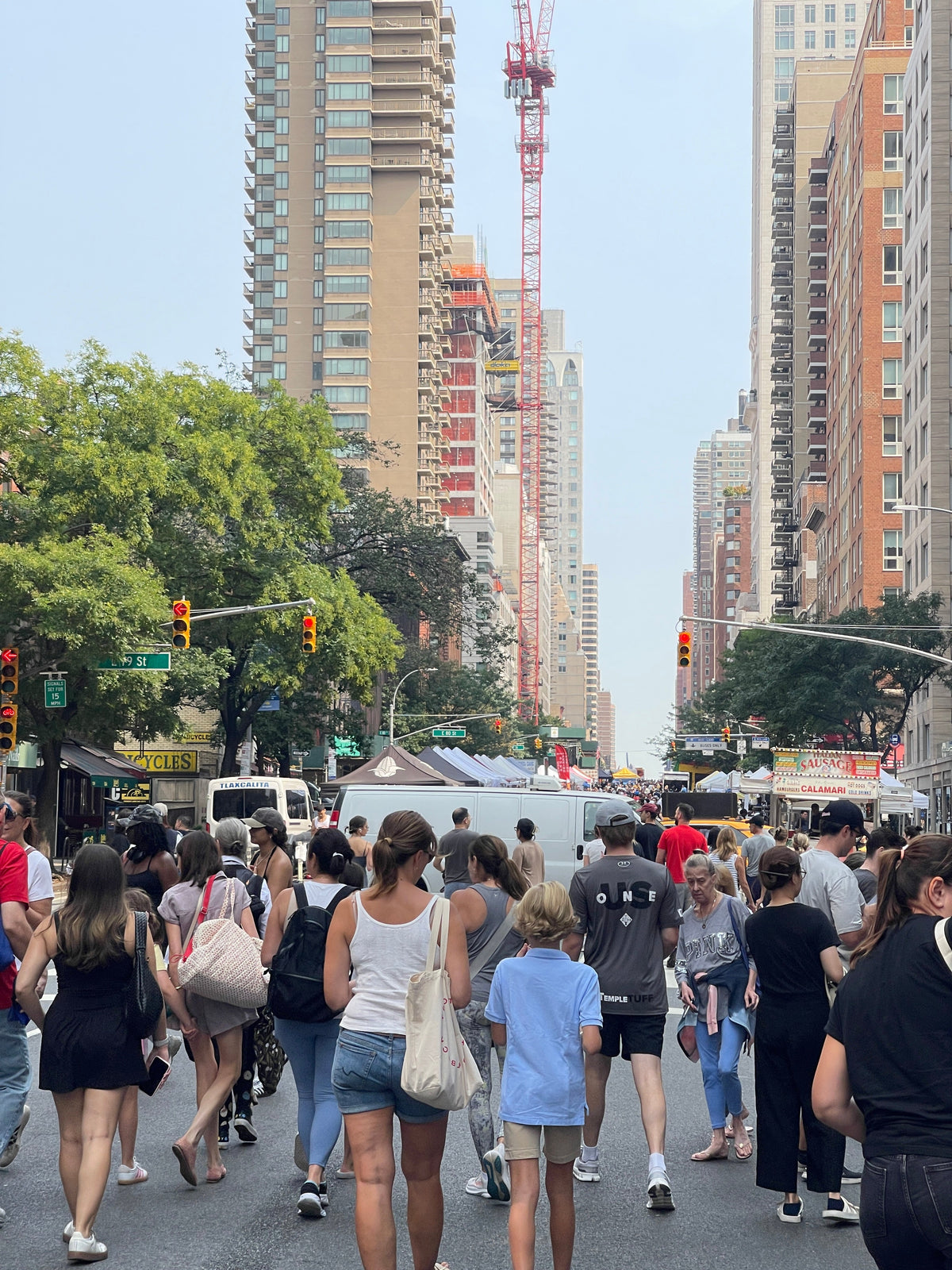 People walking the street fair on 3rd Ave NYC