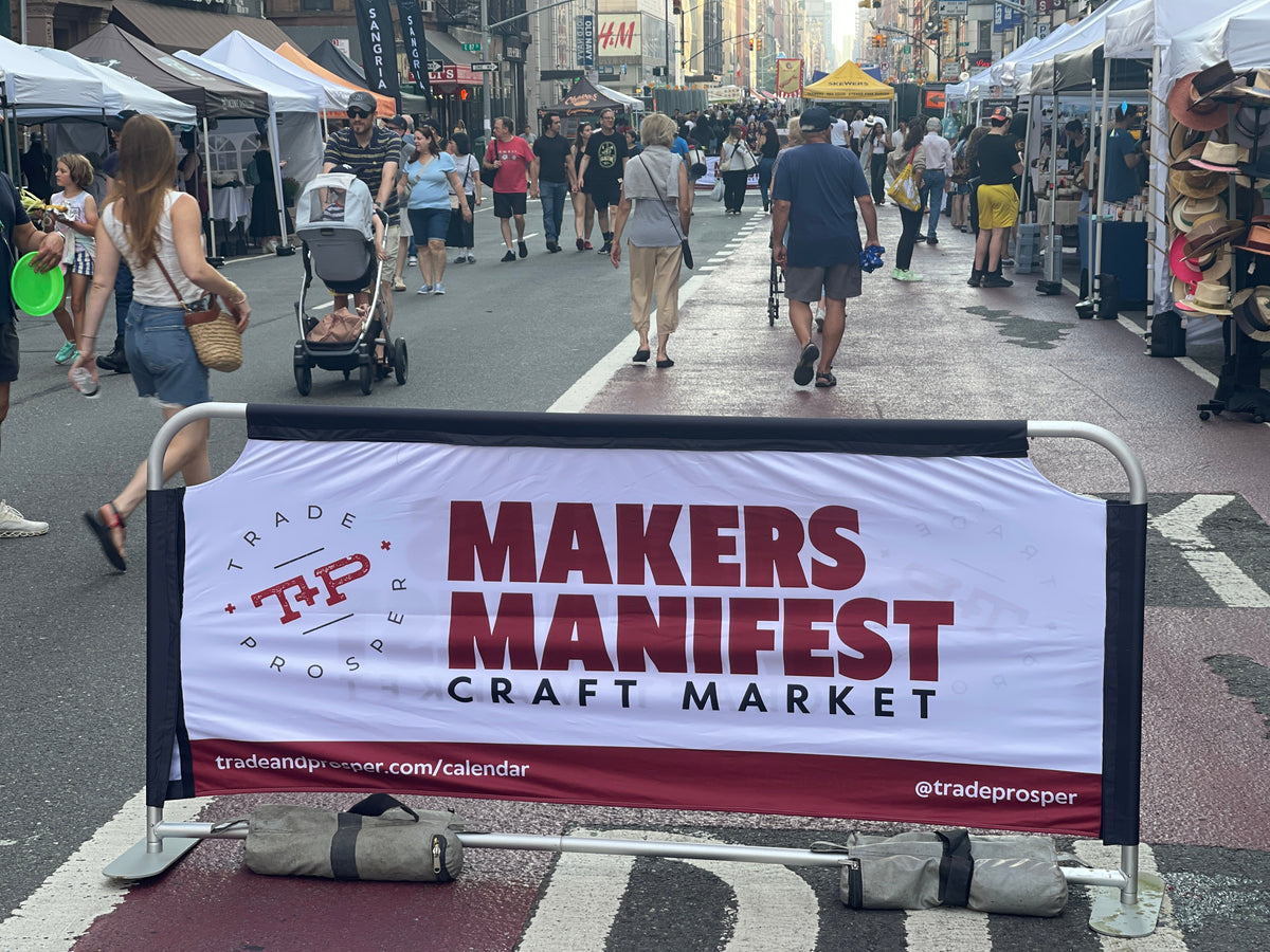 Street scene upper east side with makers manifest sign and pop up tents