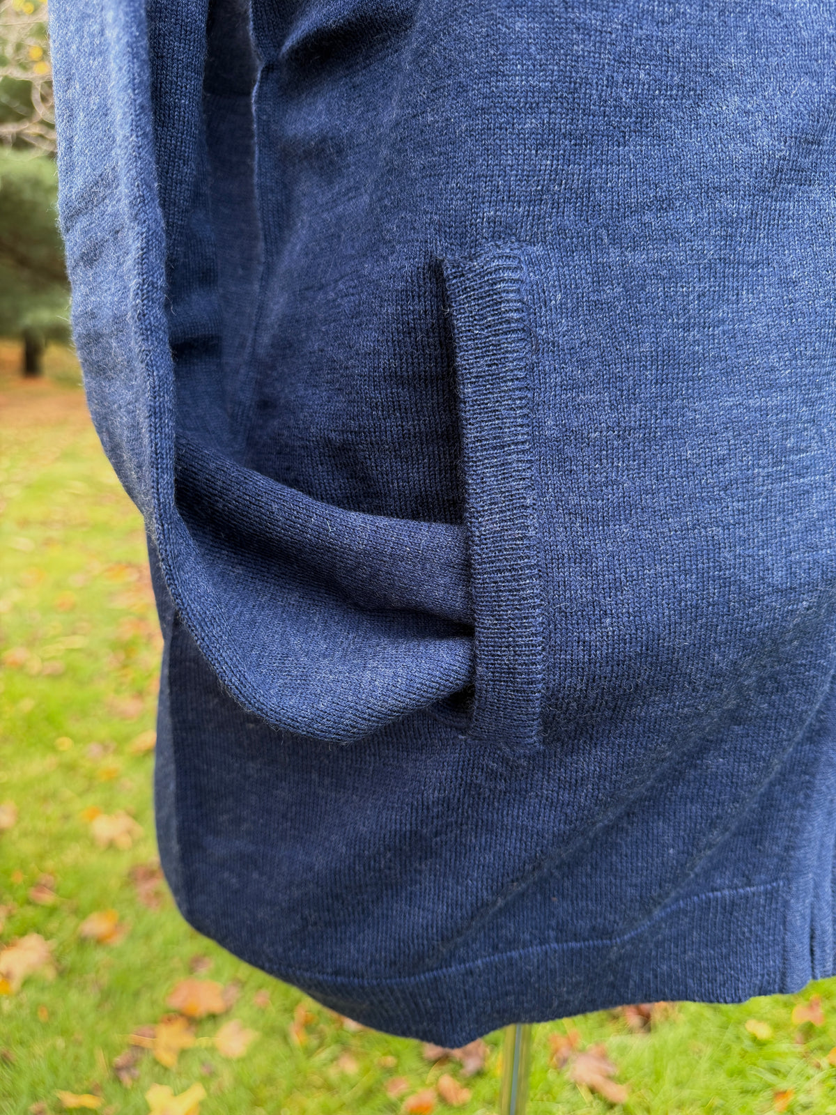 close up photo of sleeve tucked into knit pocket to show rib trim at pocket and bottom edge