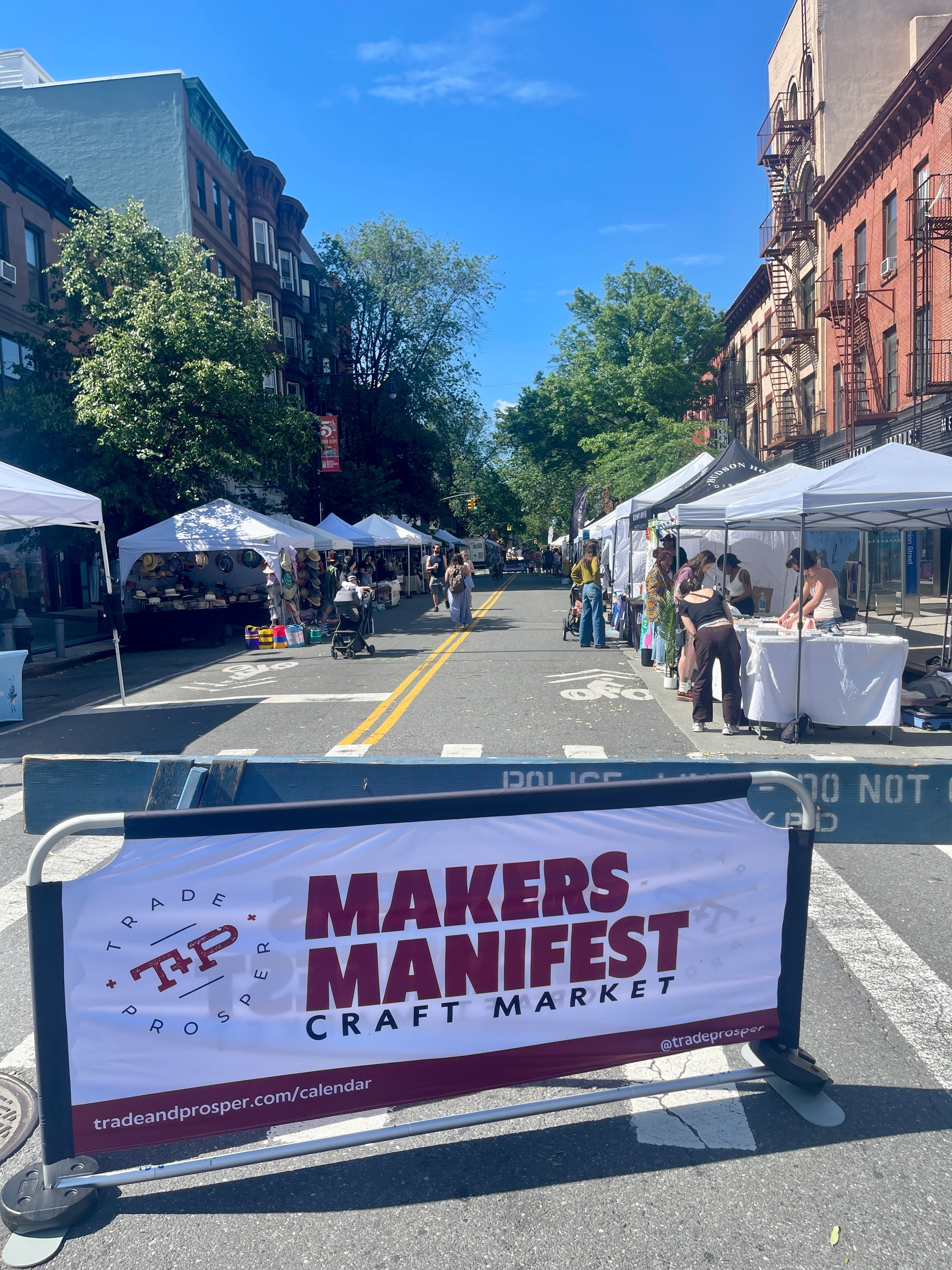Makers Manifest banner on street in front of pop up tents in Brooklyn NY
