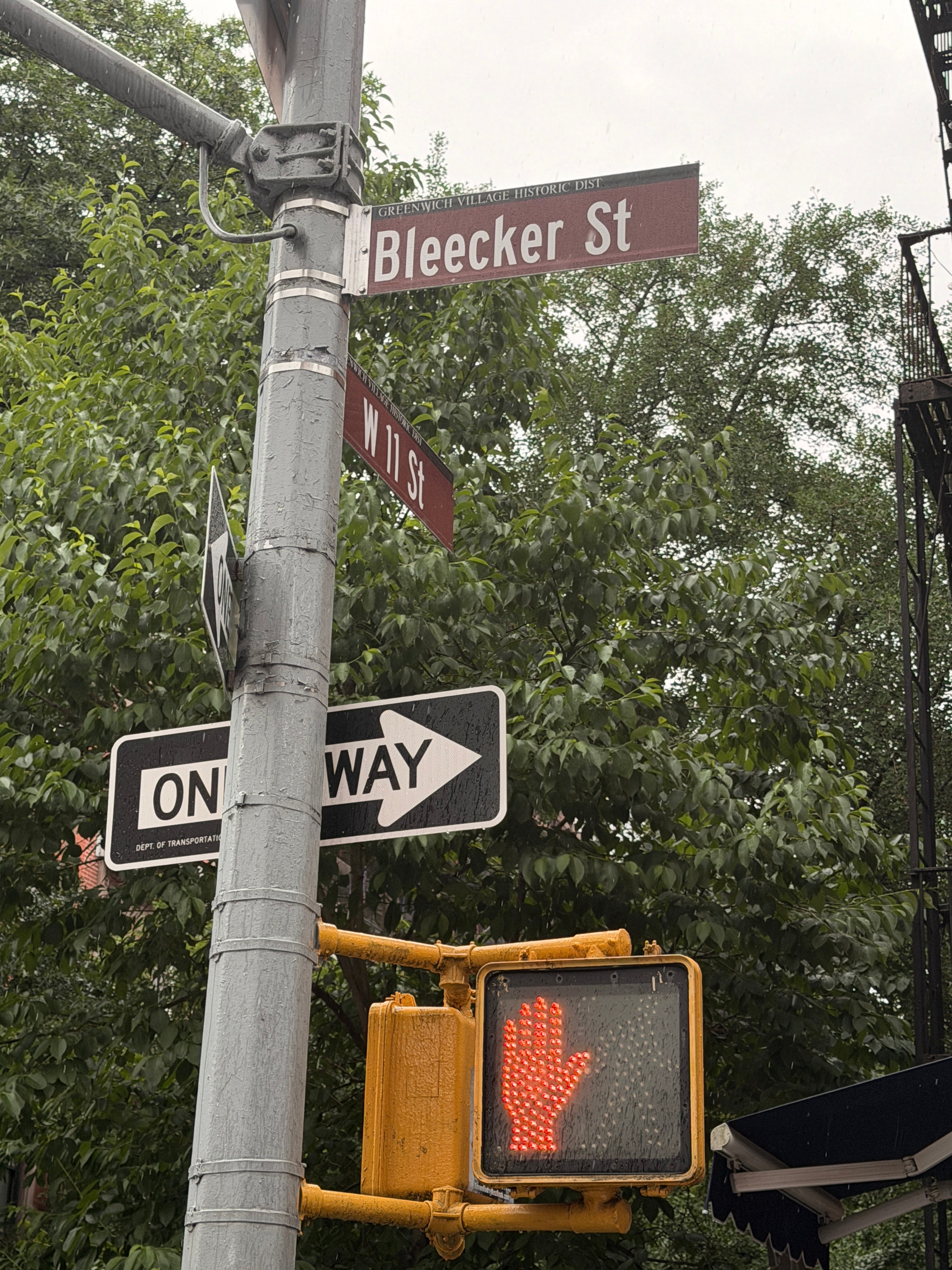 sign post showing corner of Bleeker and W11 ST in NYC